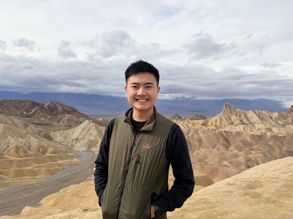 Henry Hung standing outdoors in Death Valley, badlands in the background